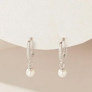 Sterling Silver Diamante Pearl Earrings hanging down from a display stand.